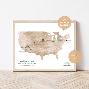May include: A framed map of the United States with travel destinations marked. The map is in shades of brown and tan, with text that reads "Katherine & Tom's The Great Adventure March 2026". Includes text that says "Any Country Available" and "Digital File".