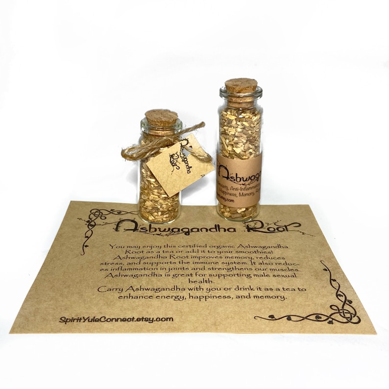 May include: Two small glass bottles with cork stoppers filled with dried herbs. The bottles are labeled "Ashwagandha Root". The bottles are sitting on a brown paper card with text about the benefits of Ashwagandha Root.