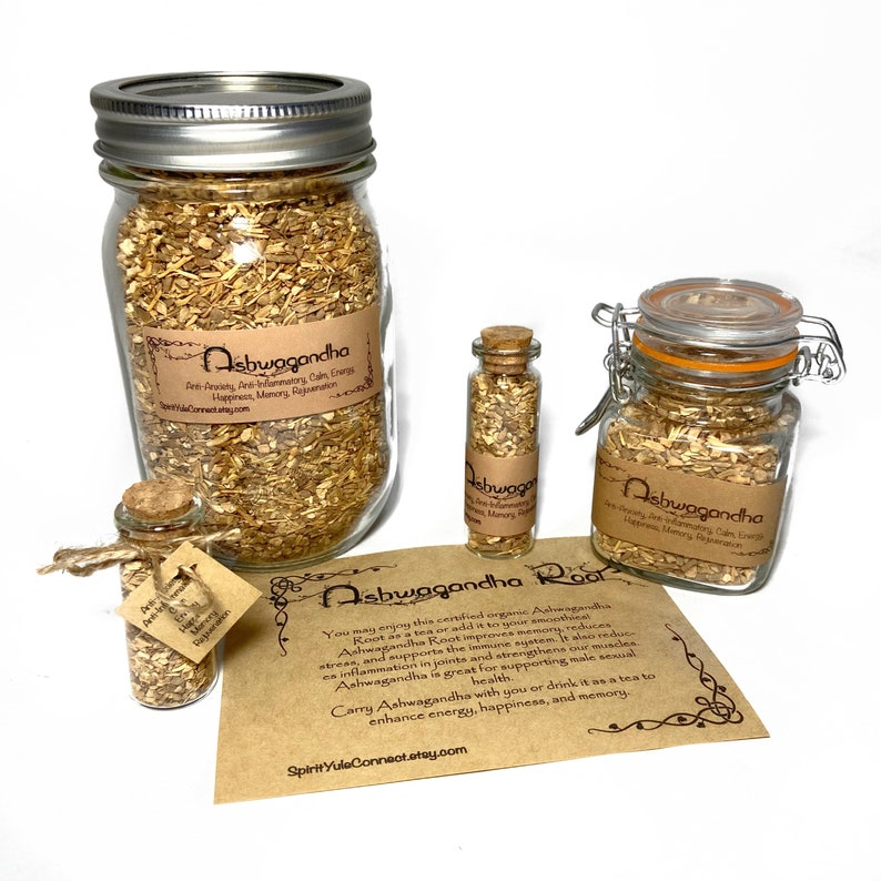 May include: Three glass jars of varying sizes filled with dried ashwagandha root. The jars have cork or metal lids. A brown paper card with the text "Ashwagandha Root" and information about the benefits of ashwagandha is in the foreground.