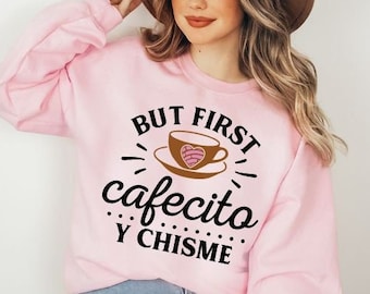 May include: Pink sweatshirt with the text "But first, cafecito y chisme" and a cartoon coffee cup with a heart design.