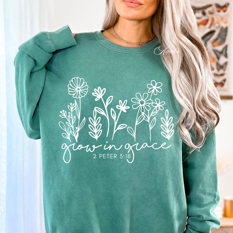 May include: A green sweatshirt with a white graphic of flowers and the text "grow in grace 2 Peter 3:18".