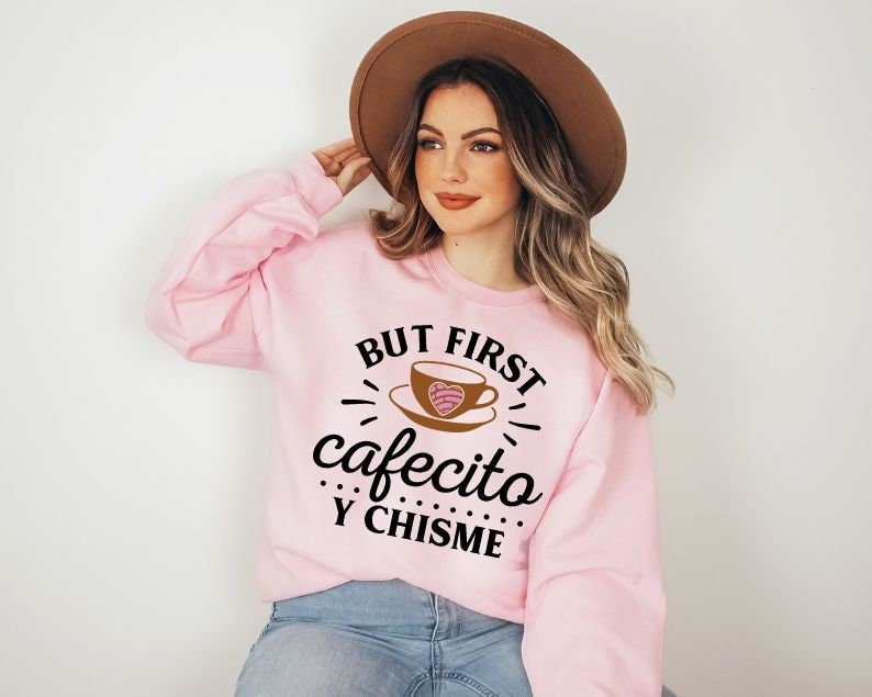 May include: Pink sweatshirt with the text "But first, cafecito y chisme" and a cartoon coffee cup with a heart design.