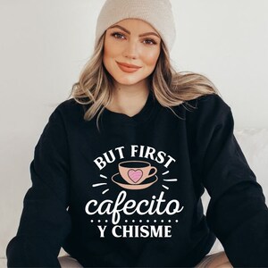 May include: A black sweatshirt with the text "BUT FIRST cafecito Y CHISME" in white. A pink heart is inside a white coffee cup graphic.