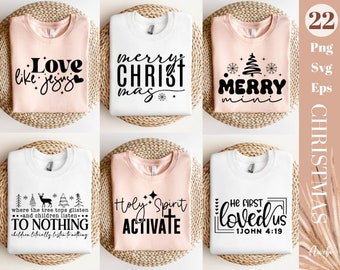 May include: Collection of six Christmas-themed t-shirts in white and light pink. Each shirt features a different black graphic and text design, including phrases like "Merry Christmas" and "Love like Jesus". The shirts are displayed on a woven surface.