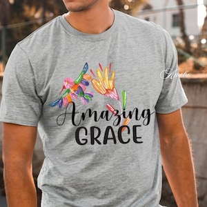 May include: A gray t-shirt with a colorful floral design and the text "Amazing Grace" printed on the front.