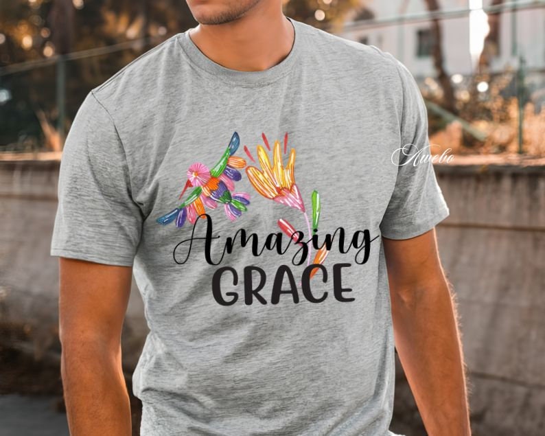 May include: A gray t-shirt with a colorful floral design and the text "Amazing Grace" printed on the front.