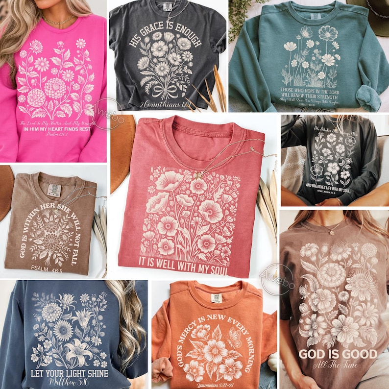 May include: A collection of various-colored t-shirts and sweatshirts, each featuring floral designs and inspirational text. The shirts are in shades of pink, gray, teal, red, brown, and orange. The text includes phrases like "His Grace is Enough" and "It is Well With My Soul."