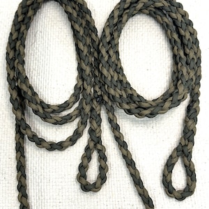 May include: Two green and brown braided paracord lanyards with loops at the ends.