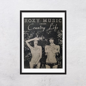May include: Framed black and white poster for Roxy Music's album "Country Life." The poster features two women in lingerie, with the album title and band name at the top. The background is a stylized depiction of foliage.