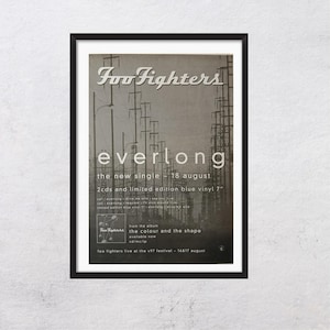 Puede incluir: Póster enmarcado en blanco y negro para el sencillo "Everlong" de Foo Fighters. La imagen muestra el nombre de la banda, el título del sencillo y los detalles del lanzamiento. El póster también incluye el título del álbum e información del concierto.