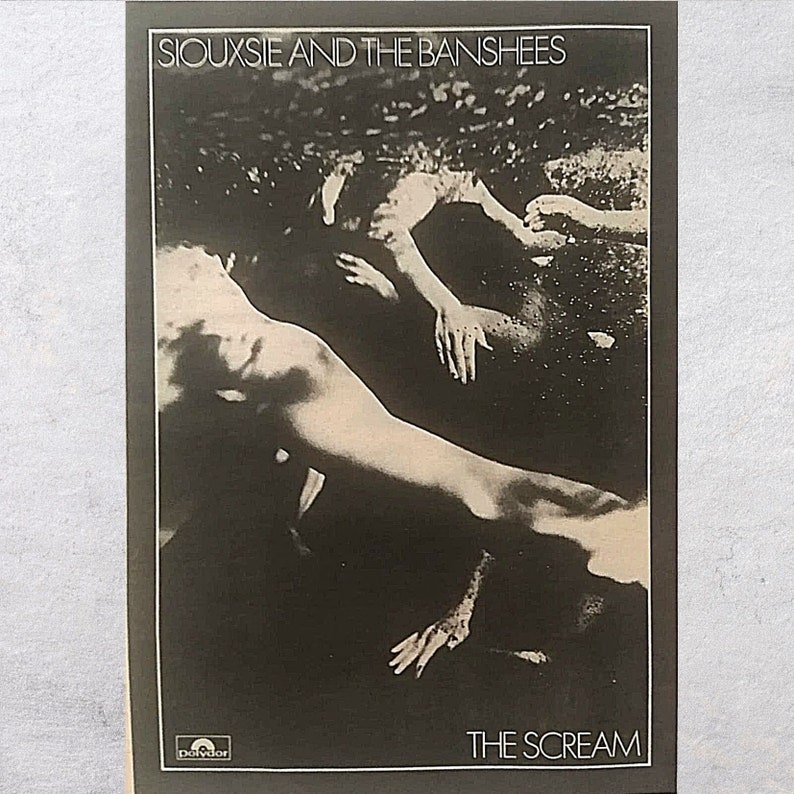 May include: Black and white album cover for Siouxsie and the Banshees' album "The Scream". The cover features a photo of two people lying in water.