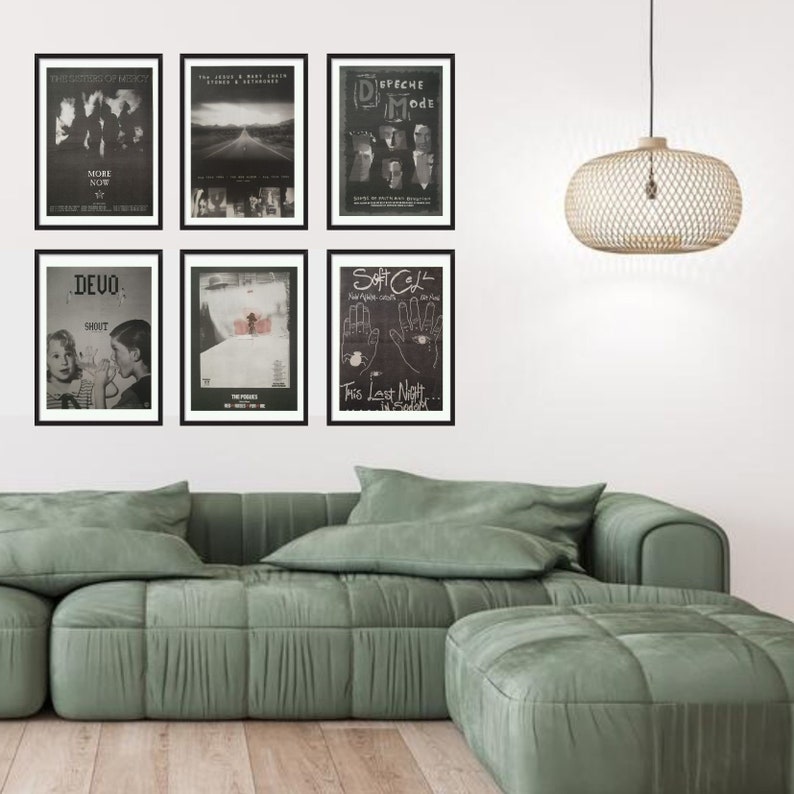 May include: A living room interior with a green sectional sofa and a matching ottoman. Six black framed posters are hung on the wall above the sofa. The posters feature black and white images of bands and music groups, including Devo, Soft Cell, and Depeche Mode.
