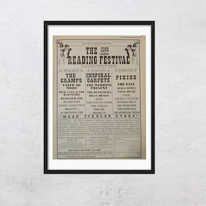 May include: A framed vintage poster for the 1990 Reading Festival, featuring a list of bands including The Cramps, Inspiral Carpets, and Pixies. The poster has a cream background with black text and decorative elements.