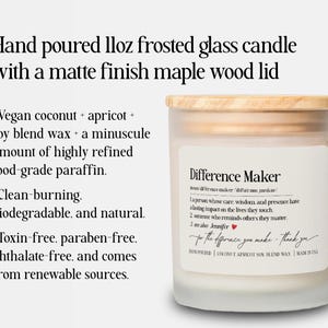 May include: A hand-poured frosted glass candle with a matte finish maple wood lid. The candle has a label that reads "Difference Maker" and includes a definition. The candle is made with vegan coconut, apricot, and soy blend wax.