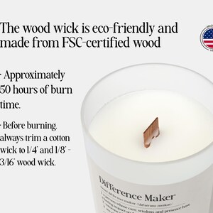 May include: A clear glass candle with a wooden wick, filled with white wax. The candle has a label that reads "Difference Maker." The text on the image states the candle has approximately 50 hours of burn time.