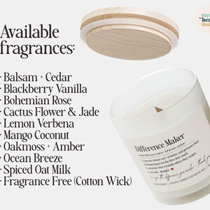 May include: A white glass candle with a wooden lid, labeled "Difference Maker." The candle's available fragrances are listed, including Balsam + Cedar, Blackberry Vanilla, and Mango Coconut. The candle has a cotton wick.