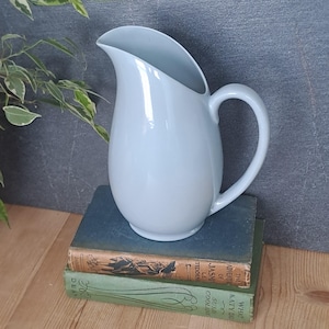 May include: A rustic wooden sign with the text "Welcome to our home" in white lettering. The sign features a distressed finish and a simple, inviting design, perfect for a front porch or entryway.