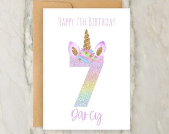 May include: A white card with a unicorn head and the number 7 in rainbow glitter. The card says "Happy 7th Birthday Darcy".