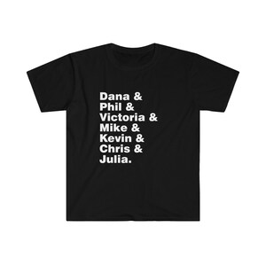 May include: Black t-shirt with white text that reads "Dana & Phil & Victoria & Mike & Kevin & Chris & Julia."