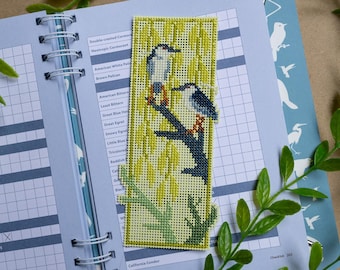 May include: A rectangular needlepoint bookmark featuring two birds perched on a dark blue branch against a background of yellow willow leaves. The design is stitched on a light-colored grid canvas with a green border and green branch at the base.