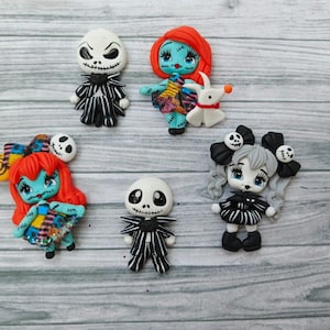 May include: A collection of handmade polymer clay figurines featuring characters from "The Nightmare Before Christmas." The figures include Jack Skellington, Sally, and other characters, with detailed black and white striped outfits and colorful accents.