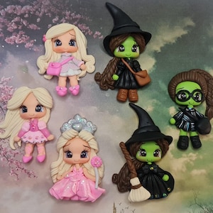 May include: Set of six handmade polymer clay figurines. The figurines are of various characters, including a witch with a green face and a black dress, a girl with pink hair and a pink dress, a girl with blonde hair and a pink dress, a girl with blonde hair and a blue dress, a girl with blonde hair and a pink dress, and a girl with blonde hair and a pink dress.
