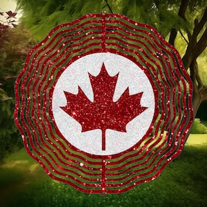 May include: A red and white metal wind spinner with a glitter finish. The spinner features a stylised Canadian maple leaf design.