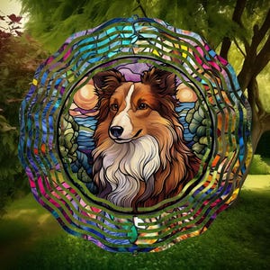 May include: A colourful stained glass wind spinner featuring a Sheltie dog with brown, white and black fur. The wind spinner has a circular design with multiple layers of glass.