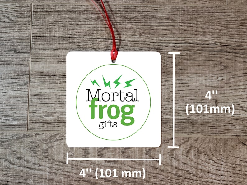 May include: White square gift tag with a green circle logo that says "Mortal frog gifts" with lightning bolts around the circle. The tag measures 4 inches by 4 inches.