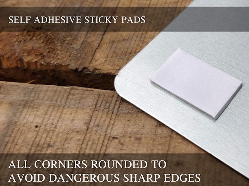 May include: Close-up of a silver metal sign with rounded corners and self-adhesive sticky pads on the back. The text "SELF ADHESIVE STICKY PADS" and "ALL CORNERS ROUNDED TO AVOID DANGEROUS SHARP EDGES" is printed on the sign.