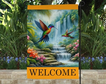 May include: A welcome garden flag with a colorful hummingbird and a waterfall in a lush green forest setting. The flag has a yellow border with the word "WELCOME" printed in black.