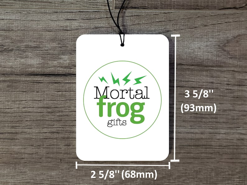 May include: White car air freshener with a green circle logo that says "Mortal frog gifts" with lightning bolts around the circle. The air freshener is 3 5/8 inches tall and 2 5/8 inches wide.
