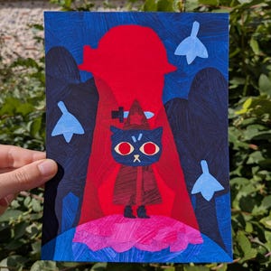May include: A rectangular art print featuring a dark blue cat with red eyes wearing a pointed hat and cloak. The cat stands on a pink textured base against a bright red background with a sword silhouette, surrounded by dark blue trees and light blue leaves.