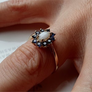 Anello vintage in oro 9 carati con opale e zaffiro blu. Anello in oro 9 carati con opale e zaffiro blu.