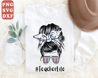 May include: White sweatshirt with a black and white illustration of a woman with a messy bun. The bun has a colorful bow with a pattern of school supplies. The woman is wearing sunglasses with a colorful pattern of crayons. The text "#TeacherLife" is printed below the illustration.