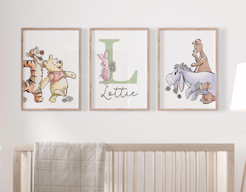 May include: Three framed wall art prints featuring Winnie the Pooh characters. The left print shows Tigger and Pooh. The center print displays a large green letter L, Piglet, and the name Lottie. The right print depicts Eeyore, Kanga, and Roo.