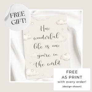 May include: A rectangular wall print featuring the black cursive text How wonderful life is now you're in the world. The background is a light cream color decorated with soft watercolor illustrations of fluffy clouds and small stars.