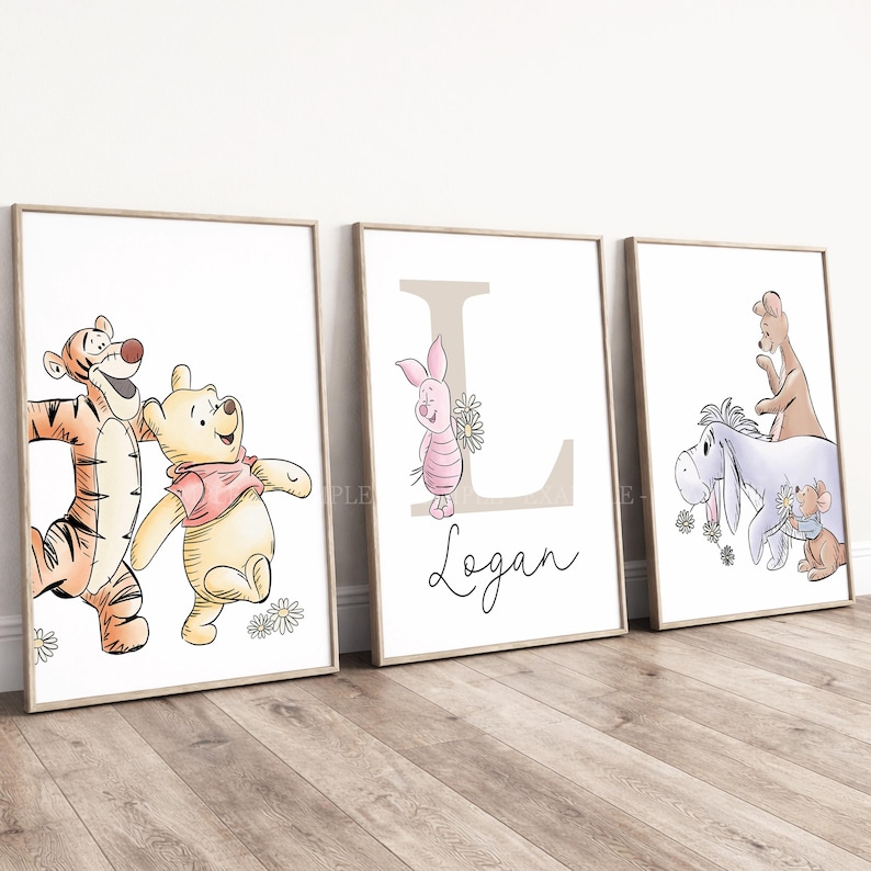 May include: Three framed wall art prints featuring Winnie the Pooh characters. The first shows Tigger and Pooh, the second features Piglet with a large letter L and the name Logan, and the third depicts Eeyore, Kanga, and Roo with flowers.