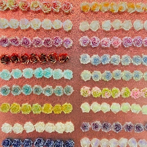 May include: A display board featuring twenty-one rows of small, decorative rose-shaped embellishments in various colors, including red, pink, yellow, blue, purple, and white. Each row is numbered from 1 to 21, arranged on a textured, copper-colored surface.