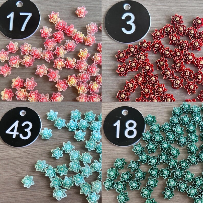 May include: A collection of small, multi-petaled flower-shaped embellishments in four distinct color groups: pink and yellow, deep red, light blue, and dark green. Each group is labeled with a black circular tag numbered 17, 3, 43, or 18.