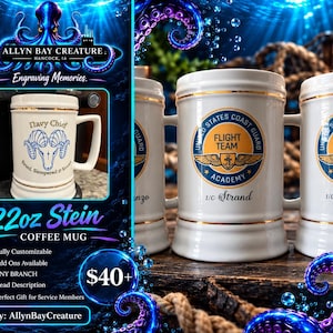 May include: A white ceramic stein coffee mug with a gold rim, featuring a circular United States Coast Guard Flight Team Academy emblem in blue, orange, and gold. The mug includes the text 1/C Strand or 1/C Silber printed below the emblem.