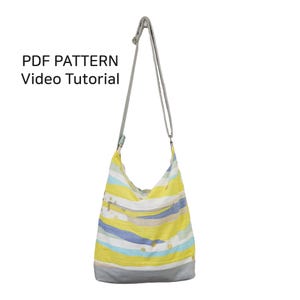 May include: A yellow, blue and white striped tote bag with a grey bottom and a long grey strap. The bag has a zipper closure and a small pocket on the front. The text "PDF PATTERN Video Tutorial" is visible at the top of the image.