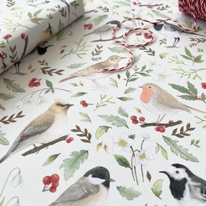 May include: White wrapping paper with a repeating pattern of watercolour illustrations of birds, flowers, and berries. The birds are in various poses, including flying, perched, and singing. The flowers are white and pink, and the berries are red.