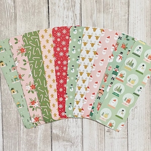 May include: A collection of ten Christmas-themed bookmarks with various patterns. Designs include houses, candy canes, gingerbread men, snowflakes, snowmen, reindeer, Santa hats, nutcrackers, and snow globes. The bookmarks are in shades of green, red, pink, and gold.
