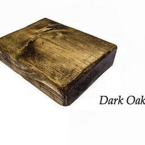 May include: A dark oak wood plank with a rough, unfinished texture. The wood has a natural, rustic look.