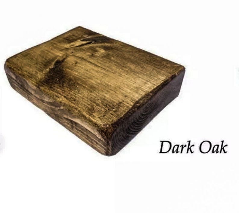 May include: A dark oak wood block with a rough, unfinished texture. The wood has a rich brown color with a slightly reddish hue.