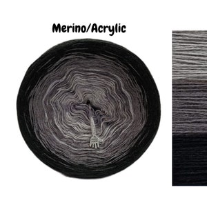 May include: A skein of black, gray, and white ombre yarn with a hand-made tag. The yarn is made of merino wool and acrylic.