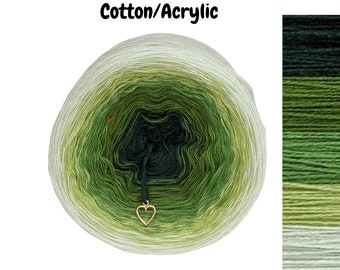 May include: A skein of green, white, and dark green ombre yarn with a gold heart charm. The yarn is labeled "Cotton/Acrylic".