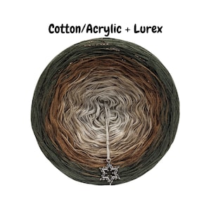 May include: A skein of yarn in shades of green, brown, and beige. The yarn is wound into a ball and has a metallic sheen. The text "Cotton/Acrylic + Lurex" is visible above the yarn.
