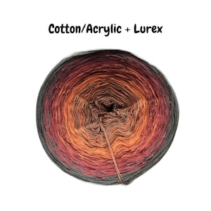 May include: A ball of yarn in shades of red, orange, and brown with a silver shimmer. The yarn is labeled "Cotton/Acrylic + Lurex".